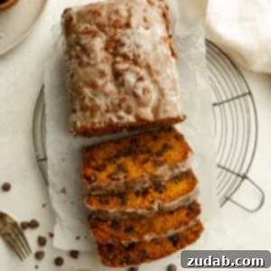 A delightful loaf of glazed pumpkin chocolate chip bread, perfectly baked and ready to be served.