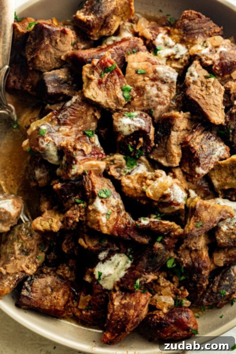 Succulent Slow Cooker Garlic Butter Steak Bites 3 tender, juicy steak bites in a large serving bowl