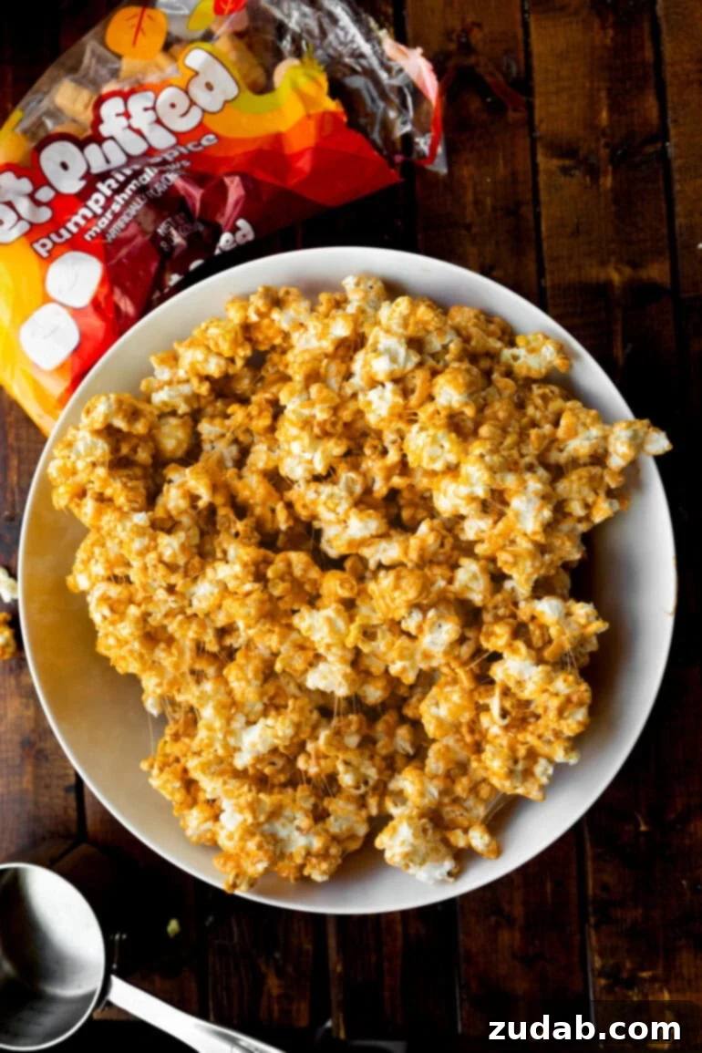 Cozy Fall Snack: Pumpkin Marshmallow Popcorn 2 A large white bowl brimming with sticky, sweet pumpkin spice marshmallow popcorn, ready for sharing.