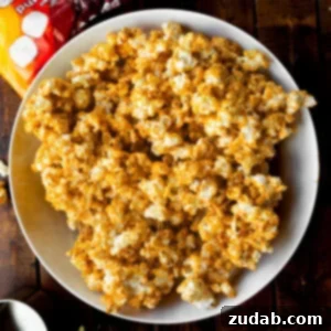Cozy Fall Snack: Pumpkin Marshmallow Popcorn 5 a large white bowl full of gooey pumpkin spice marshmallow popcorn