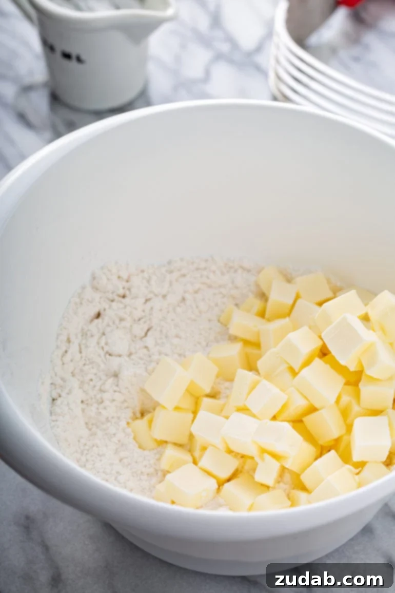 My Go-To Flaky All-Butter Pie Crust 2 A bowl containing flour and little cubes of butter.