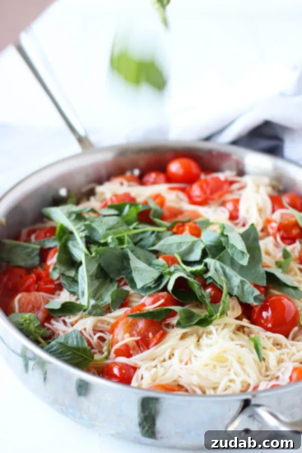 This 20 Minute Cherry Tomato and Basil Angel Hair Pasta comes together in a jiffy, and will satisfy the whole family, even the kids! angel hair pasta, tomatoes, garlic, and fresh basil in a stovetop pan