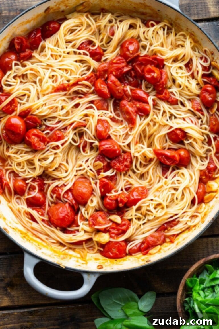 Quick and Easy 20-Minute Tomato Basil Angel Hair Pasta 6 a photo of cooked angel hair pasta that has been tossed with sauteed tomatoes and garlic