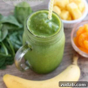 Tropical Green Power Smoothie 2 A glass of Pineapple Orange Banana Green Smoothie, perfect for a healthy breakfast.