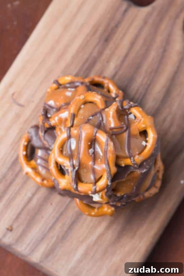 Quick & Easy Salted Caramel Pretzel Snaps An inviting close-up of a salted caramel pretzel snap, highlighting the delicate sprinkle of sea salt over the caramel and chocolate.