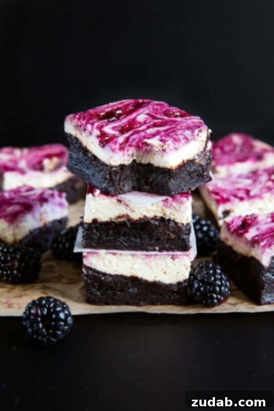 Indulge in the Best: Homemade Blackberry Cheesecake Brownies Blackberry cheesecake brownies that will have everyone begging for seconds, showcasing the rich, deep colors and inviting textures.