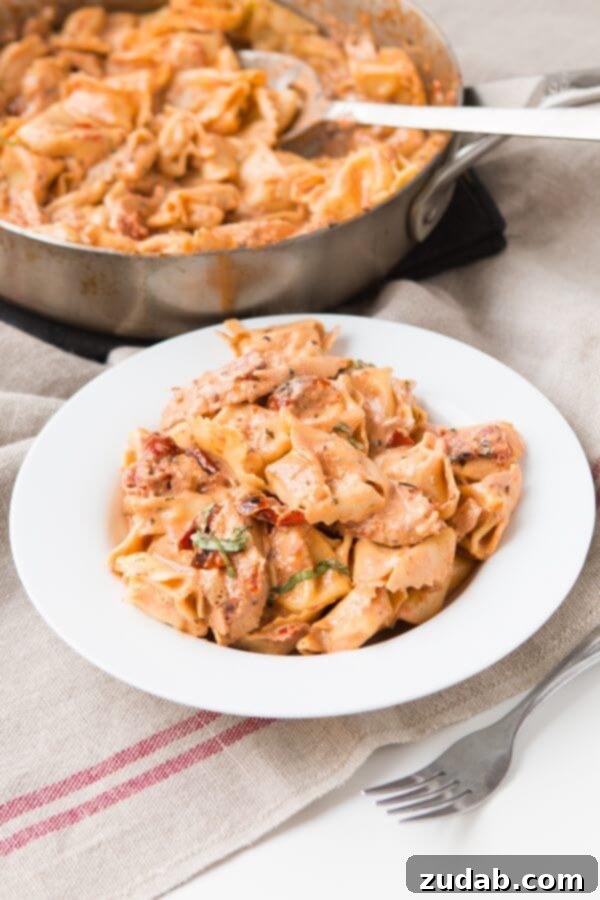 Creamy and Delicious: Basil Sun-Dried Tomato Chicken Tortellini A delicious serving of Basil Sun-Dried Tomato Chicken Tortellini, perfectly cooked and garnished with fresh basil.