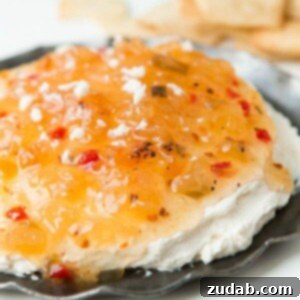 Tropical Fire Dip 2 A vibrant bowl of Pineapple Habanero Dip with crispy pita chips ready to be served.