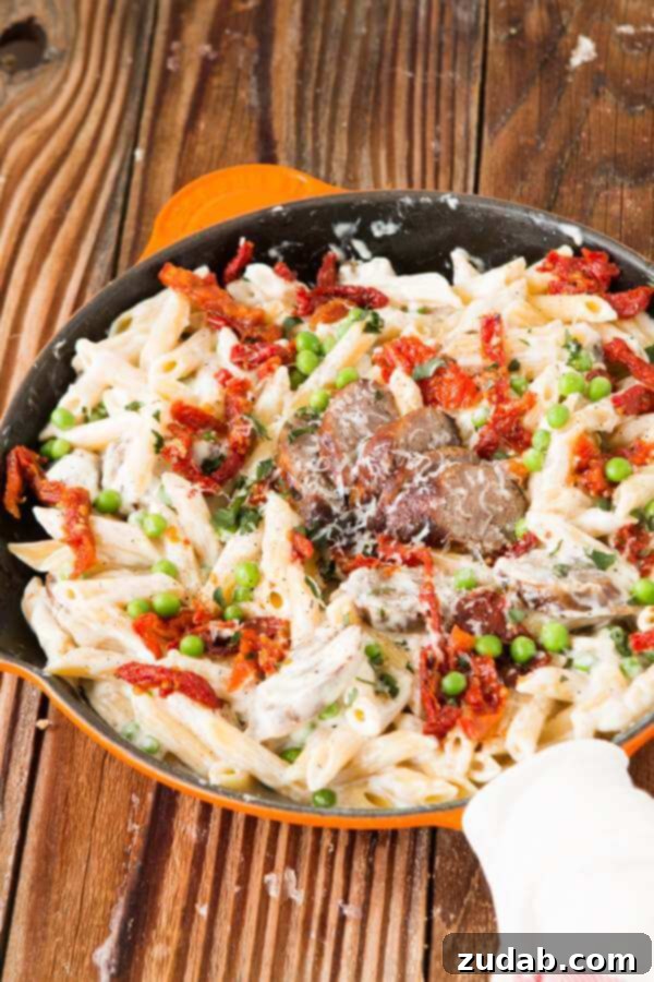 Easy Sausage Alfredo Pasta - A Modern Twist on a Classic Delicious Easy Sausage Alfredo Pasta with golden brown sausages, creamy sauce, and fresh parsley garnish, perfect for a quick weeknight dinner