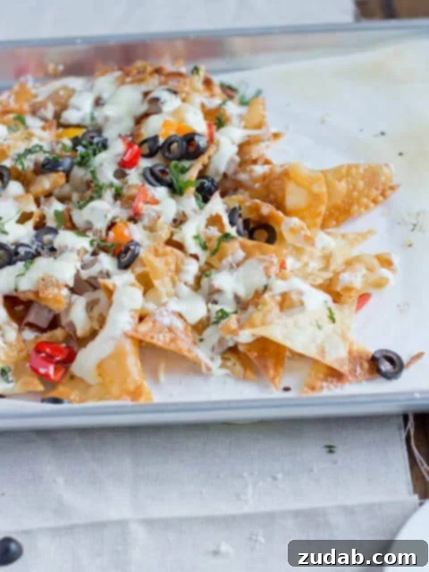 Quick and Creamy Sausage Alfredo Pasta 4 A plate of Italian nachos with crispy pasta chips, melted cheese, and fresh toppings, ready to be served