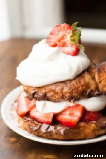 Grilled croissants filled with rich Nutella and fresh mixed berries, a quick and delicious dessert.