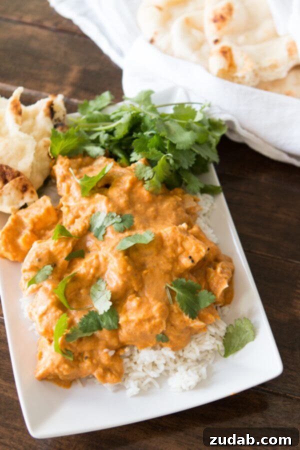 Serving Coconut Curry Chicken with Fresh Cilantro A serving of coconut curry chicken garnished with fresh cilantro, ready to be enjoyed.