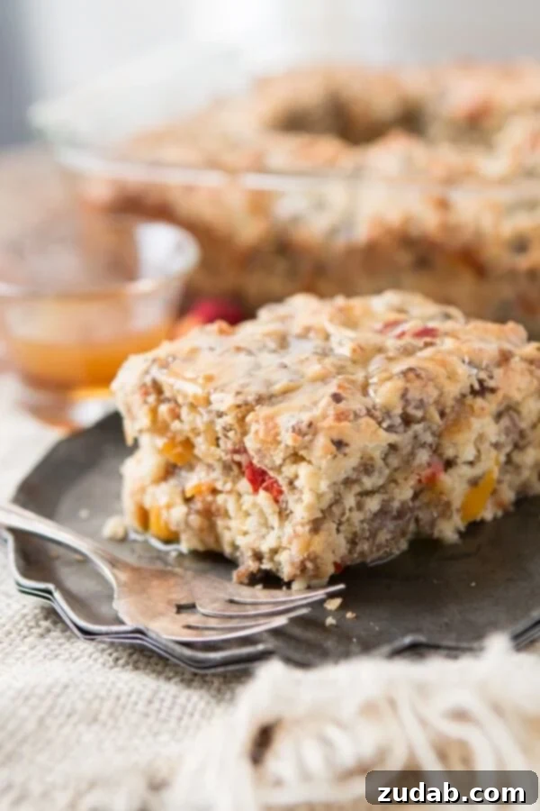 Hearty Southern Sausage Breakfast Cake Close-up of a slice of Southern Sausage Breakfast Cake, showing the hearty sausage, peppers, and cheese baked into the cake.