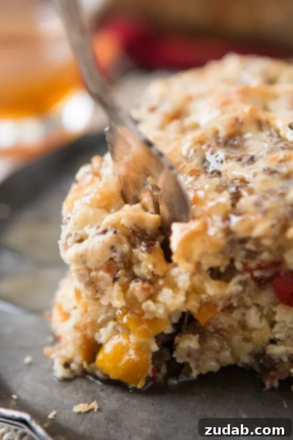 Perfectly Textured Breakfast Cake A serving of Southern Sausage Breakfast Cake on a plate, showcasing its fluffy yet dense texture.