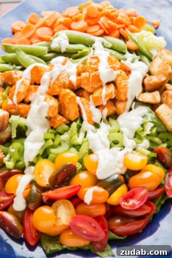 Healthy Buffalo Chicken Salad with Fresh Veggies A vibrant and healthy Buffalo Chicken Salad, rich with fresh, colorful vegetables, tender spicy chicken, and a generous drizzle of Marzetti Blue Cheese Dressing, offering a perfect blend of flavors and textures.