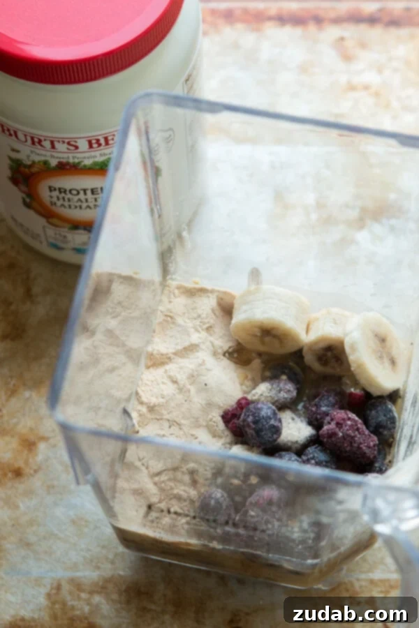 Golden Berry Protein Fuel 4 Pouring the creamy orange berry protein shake into a glass, ohsweetbasil.com