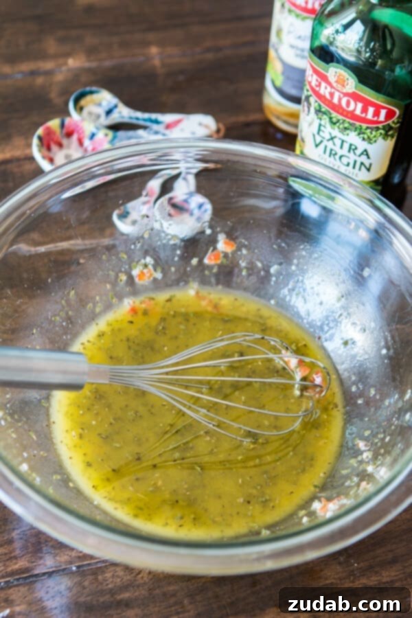 Cowboy Caviar Quinoa Recipe Video 3 Close-up of Bertolli Extra Virgin Olive Oil, highlighting its rich quality and essential role in enhancing the flavors of healthy dishes like quinoa salad.