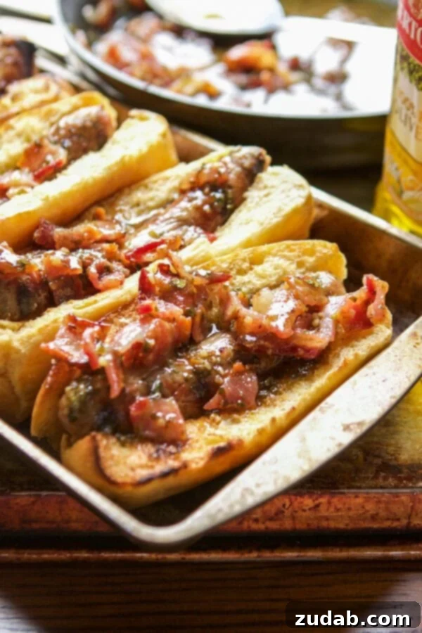 Delicious Honey Mustard Bacon Brats, a perfect dinner solution. Sizzling Honey Mustard Bacon Brats on a grill, perfectly seared and ready to be sauced.