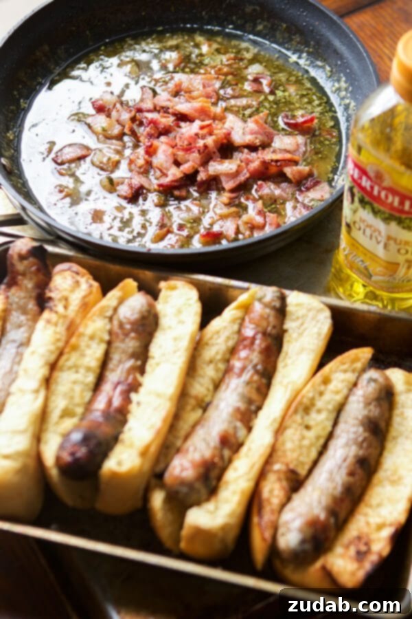 Ready to eat: Honey Mustard Bacon Brats with homemade sauce. A serving of Honey Mustard Bacon Brats on toasted buns, generously drizzled with the savory sauce.