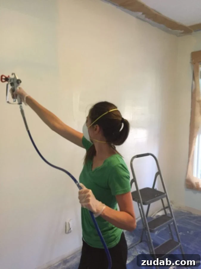 Initial stages of home office renovation: clearing and prep work. Preparing the front room for a complete home office transformation, starting with painting.