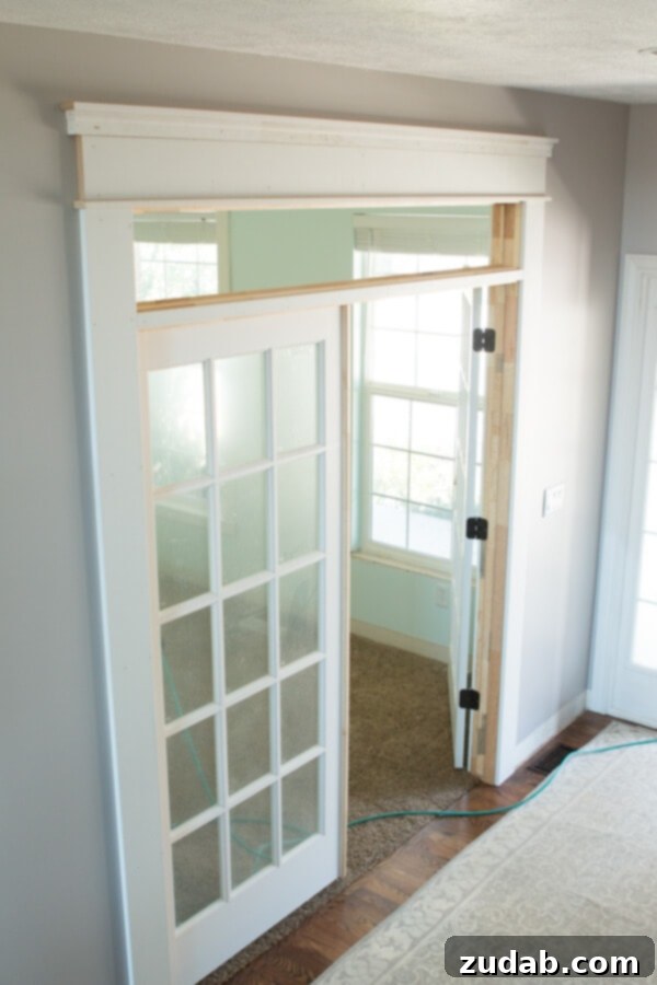 French doors defining the entrance to the new family home office. Installation of new French doors to create a quiet yet open family workspace.