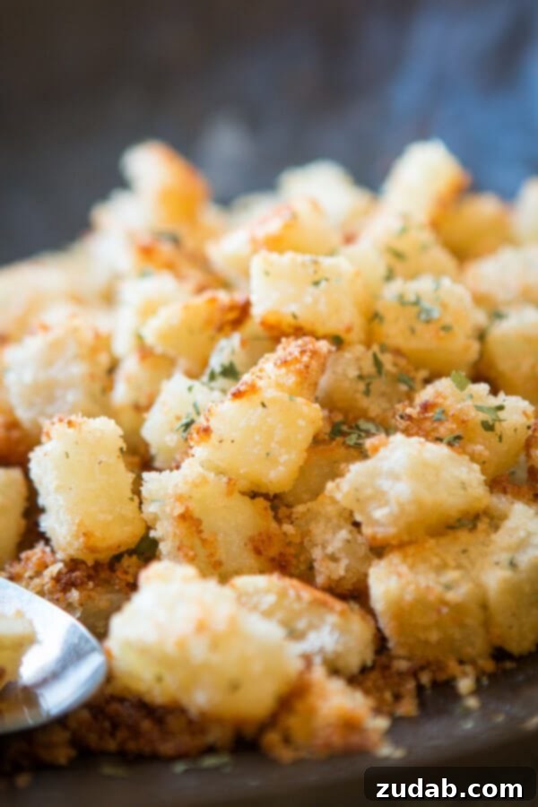 Golden brown Shake N Bake Ranch Potatoes with a crispy coating. Shake N Bake Ranch Potatoes cooling on a baking sheet, fresh from the oven.