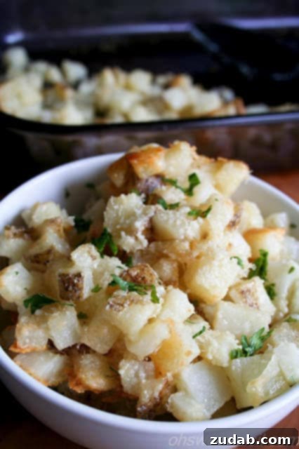 Crispy Ranch Roasted Potatoes 5 A serving of golden Cheesy Potato Bites in a small white bowl.
