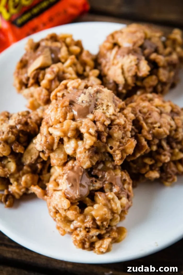 Reese's Peanut Butter Krispies Treats 2 A tantalizing close-up of Reese's Krispies, showcasing the gooey peanut butter and chocolate chunks embedded in the crispy rice cereal. Perfect for quick dessert cravings.
