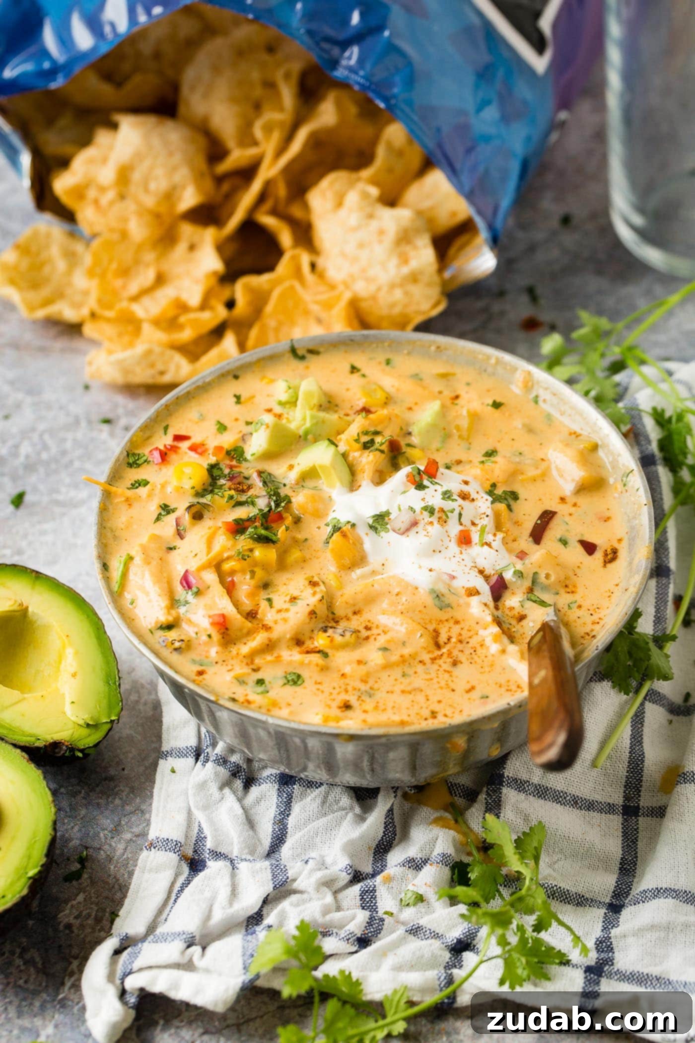 Hearty Cheesy Southwestern Chicken Tortilla Soup 8 A bowl of creamy Cheesy Chicken Tortilla Soup, elegantly garnished with sour cream and avocado.