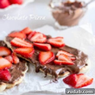 Nutella Strawberry Delight Pizza 6 Final plated image of the Nutella Strawberry Pizza, garnished and ready to be enjoyed.