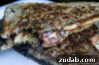 Nutella Strawberry Delight Pizza 7 Grilled Peanut Butter, Nutella, and Banana Sandwich on a serving plate.