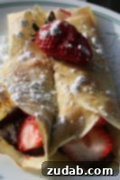 Nutella Strawberry Delight Pizza 8 Stack of freshly made Strawberry Nutella Crepes, drizzled with chocolate sauce.