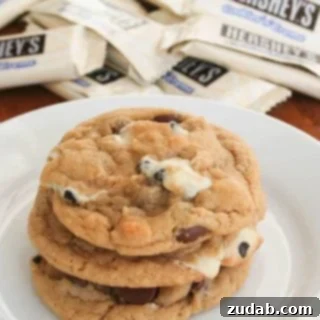 Close-up of freshly baked Cookies N Creme Chocolate Chip Cookies, showing melted chocolate and cookie pieces.