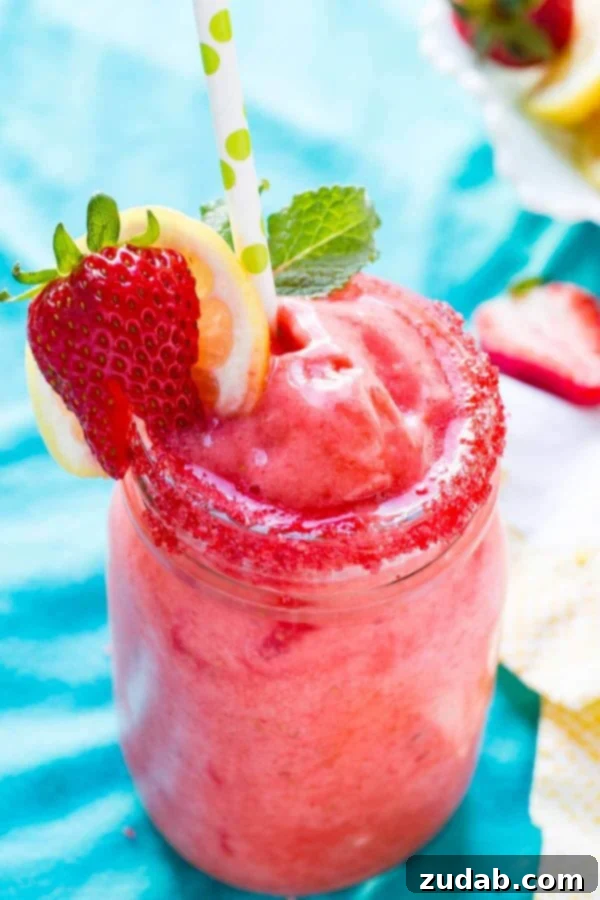 Delicious Frozen Strawberry Lemonade - Your Quick and Healthy Summer Drink A vibrant glass of Frozen Strawberry Lemonade, perfectly chilled for summer enjoyment, made with fresh strawberries and natural stevia.