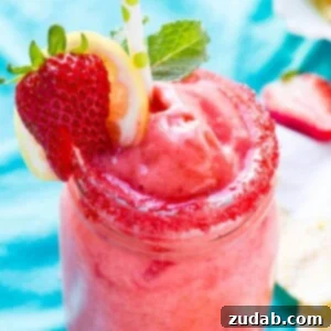 A stunning glass of Frozen Strawberry Lemonade, a refreshing and quick healthy treat from ohsweetbasil.com