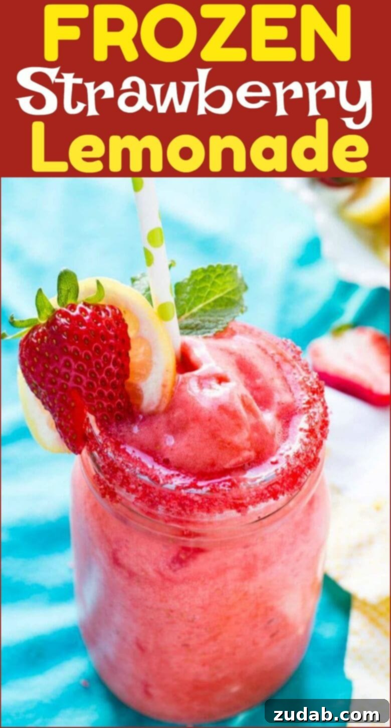 Party-Ready Frozen Strawberry Lemonade Pitcher A large pitcher of Frozen Strawberry Lemonade, garnished with lemon slices and whole strawberries, perfect for serving at a party.