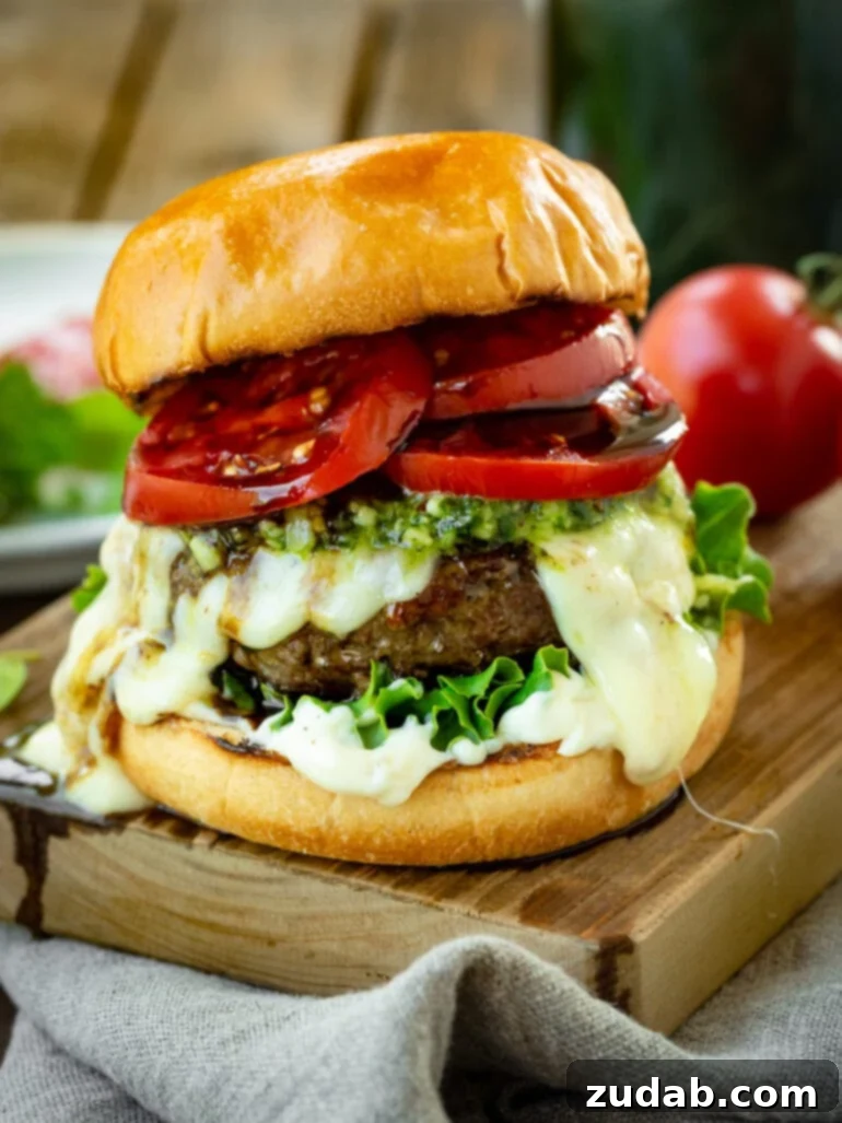 Aromatic Caprese Pesto Burgers 7 A tantalizing photo of a juicy pesto burger on a golden toasted brioche bun, generously topped with melted Havarti cheese, vibrant pesto, crisp lettuce, creamy garlic aioli, and glistening tomato slices drizzled with balsamic glaze. The quintessential gourmet burger for summer.