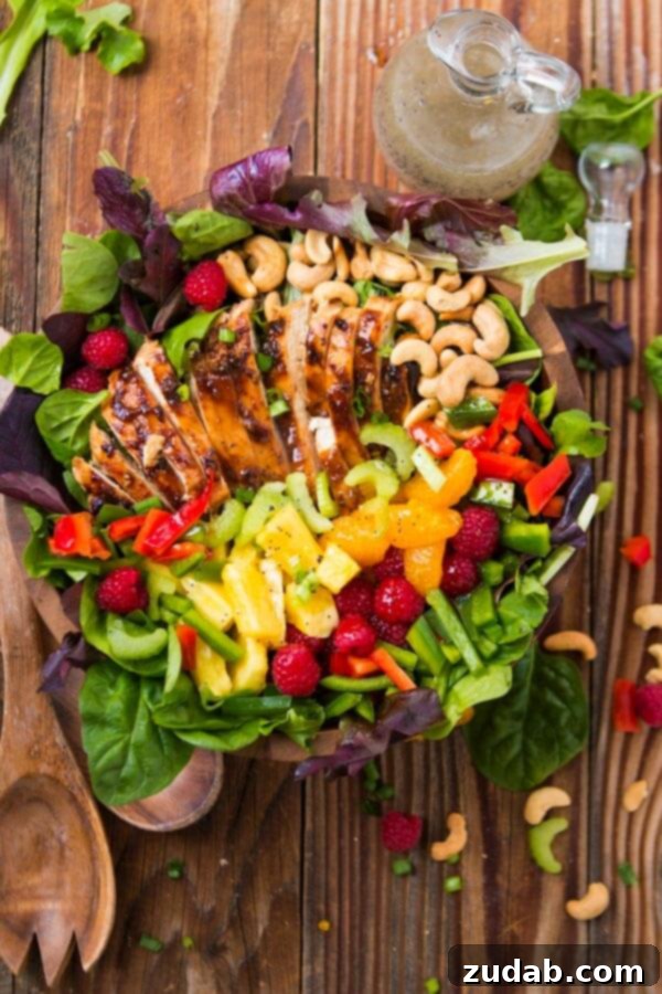Easy Teriyaki Chicken Salad: Mixed Greens, Teriyaki Chicken & Fresh Fruits with Poppy Seed Dressing A beautifully arranged Teriyaki Chicken Salad with mixed greens, succulent teriyaki chicken, an assortment of fresh fruits, and crunchy cashews, topped with a delightful poppy seed dressing.