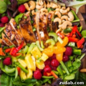 A beautifully presented Easy Teriyaki Chicken Salad, featuring succulent teriyaki chicken, fresh greens, vibrant fruits, and crunchy cashews.