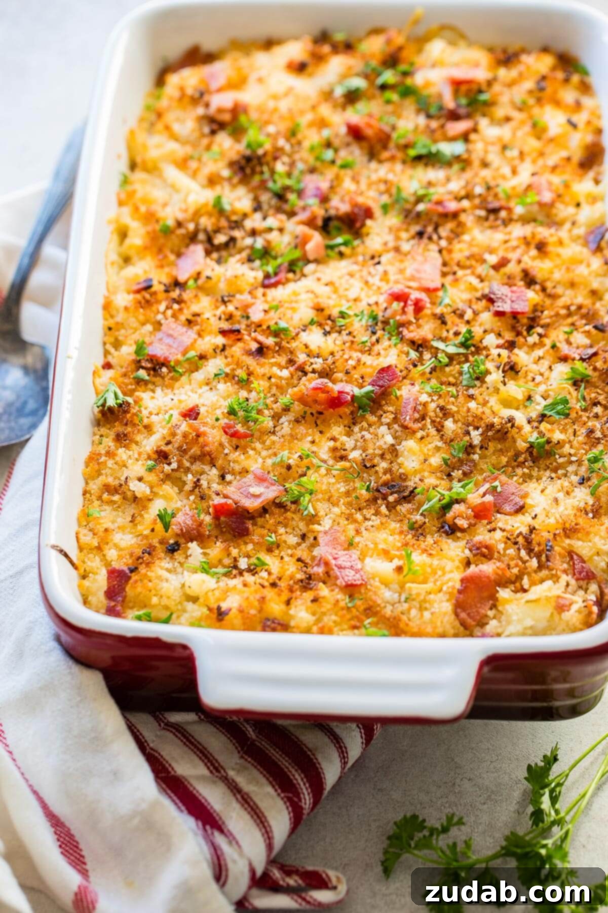 Loaded Chicken Bacon Ranch Mac and Cheese 7 a pan of chicken bacon mac and cheese on top of a tea towel, showcasing the rich, golden-brown crust