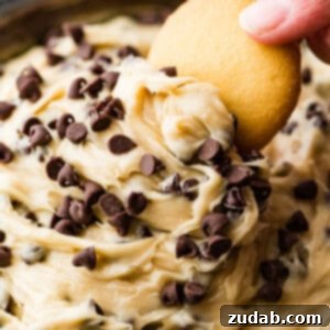 A perfectly prepared bowl of edible cookie dough dip, showcasing its creamy texture and chocolate chips.