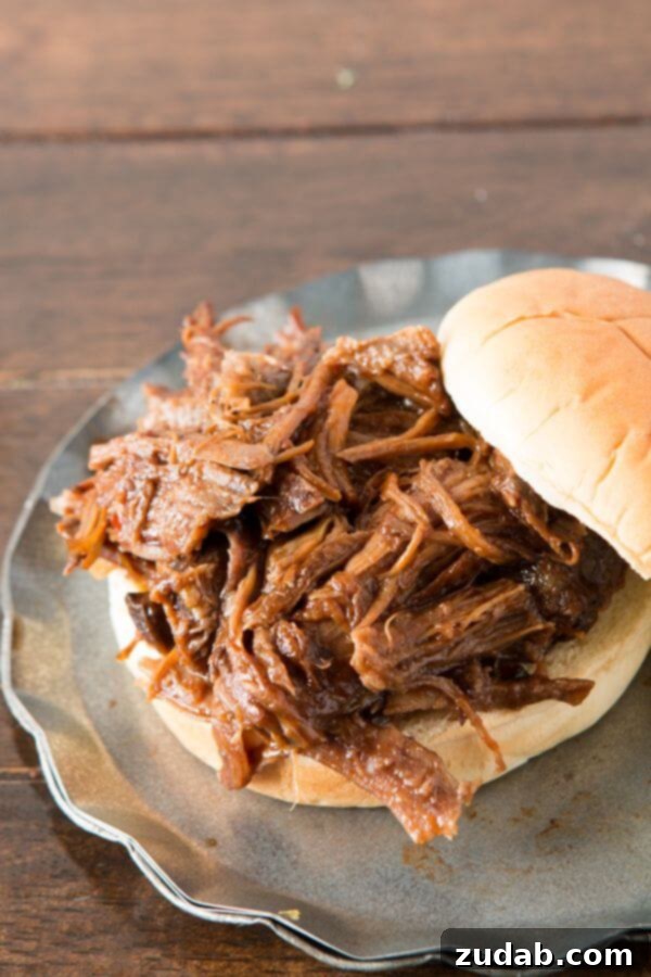 Effortless Slow Cooker BBQ Beef: A Family Favorite Recipe Succulent shredded BBQ beef cooked to perfection in a slow cooker, ready for sandwiches
