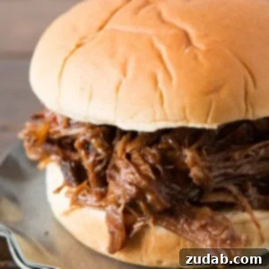 Close-up of a slow cooker BBQ beef sandwich with root beer