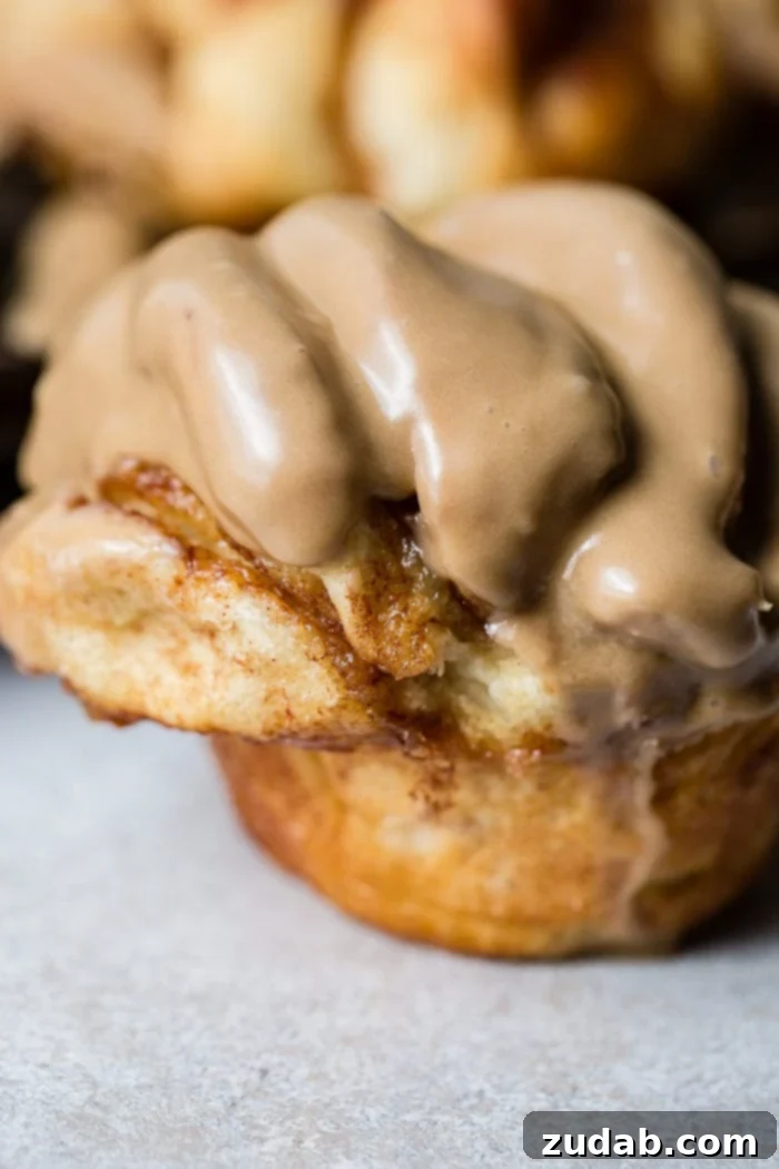 Irresistible Maple Glazed Cinnamon Butterflake Rolls 2 A close up of a cinnamon butterflake roll with maple glaze