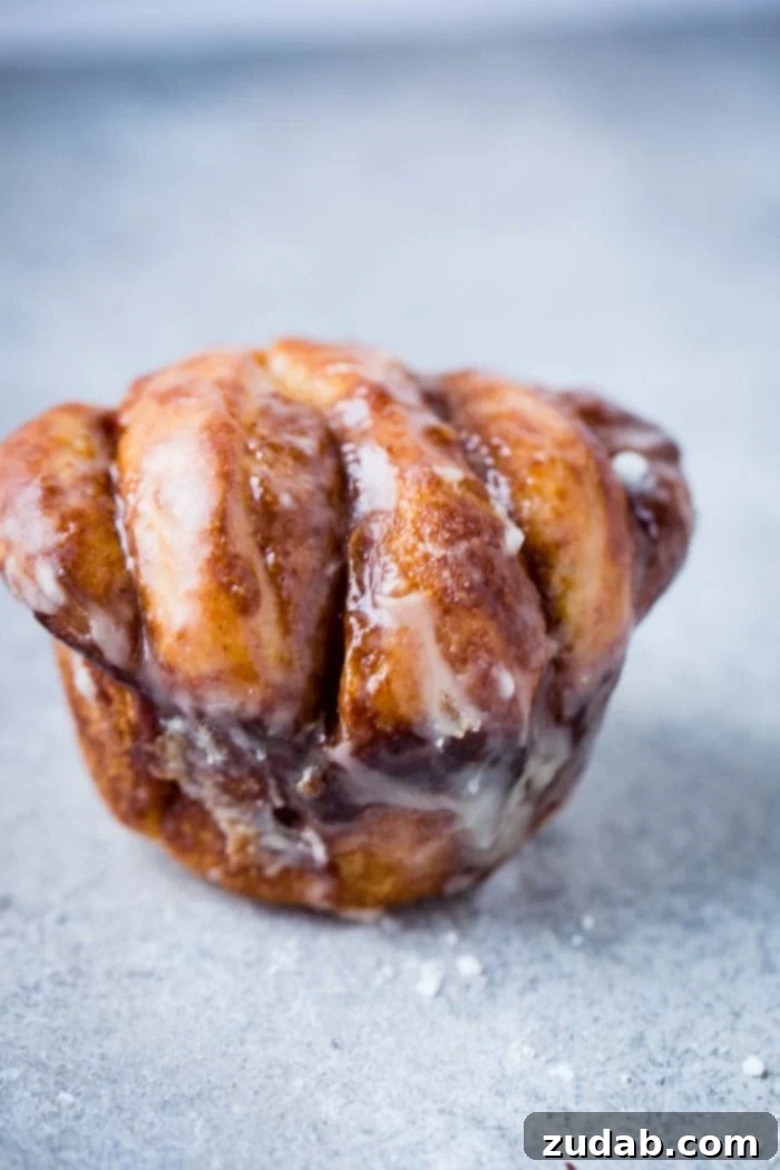 Irresistible Maple Glazed Cinnamon Butterflake Rolls 4 Up close of a maple glaze cinnamon butterflake roll