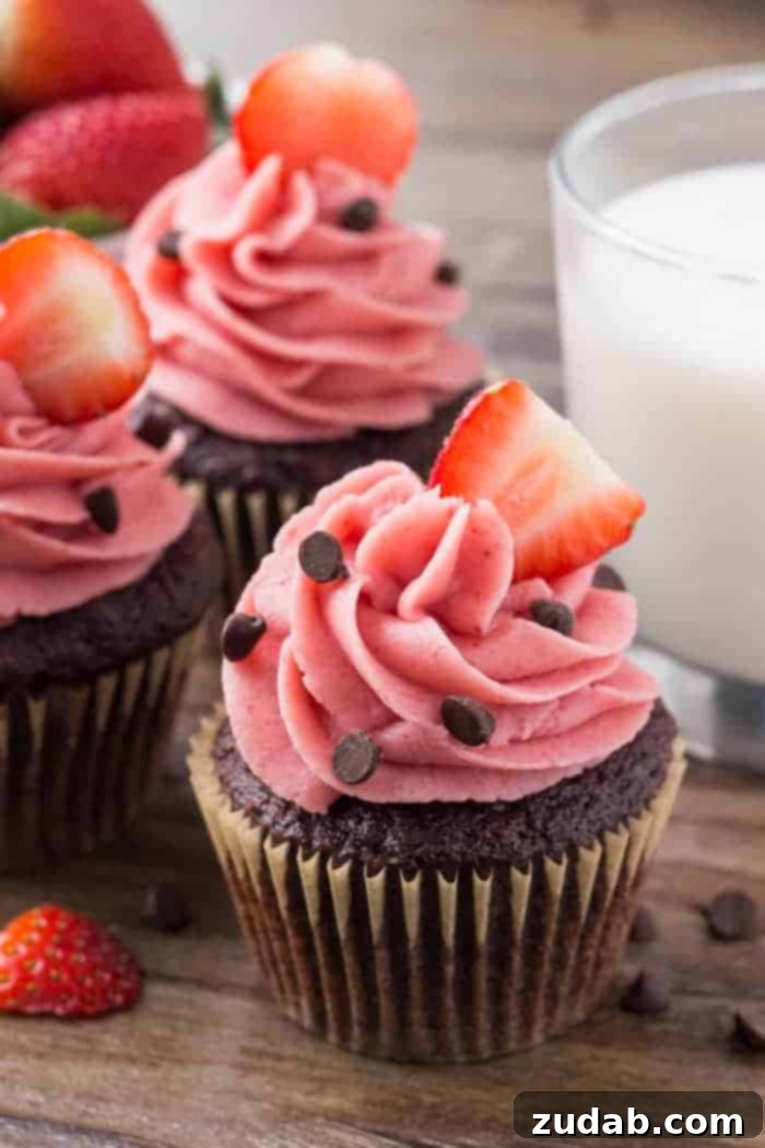 Moist, fudgy chocolate cupcakes with creamy strawberry buttercream frosting made from real strawberries.