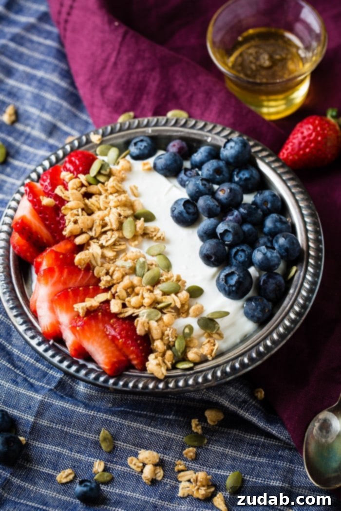 Homemade Instant Pot Yogurt 5 Instant pot homemade yogurt in a vintage bowl with a drizzle of honey and granola with pepitas and fresh blueberries and sliced strawberries for a healthy breakfast recipe