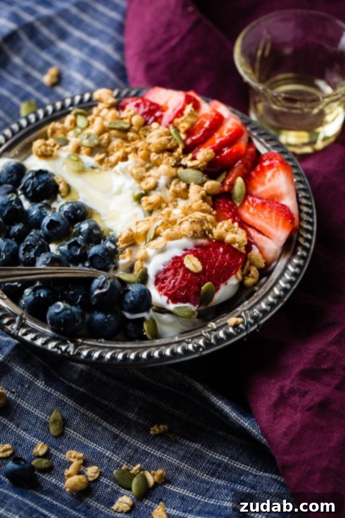 Homemade Instant Pot Yogurt 6 Instant pot yogurt in a vintage bowl with a drizzle of honey and granola with pepitas and fresh blueberries and sliced strawberries for a healthy breakfast recipe