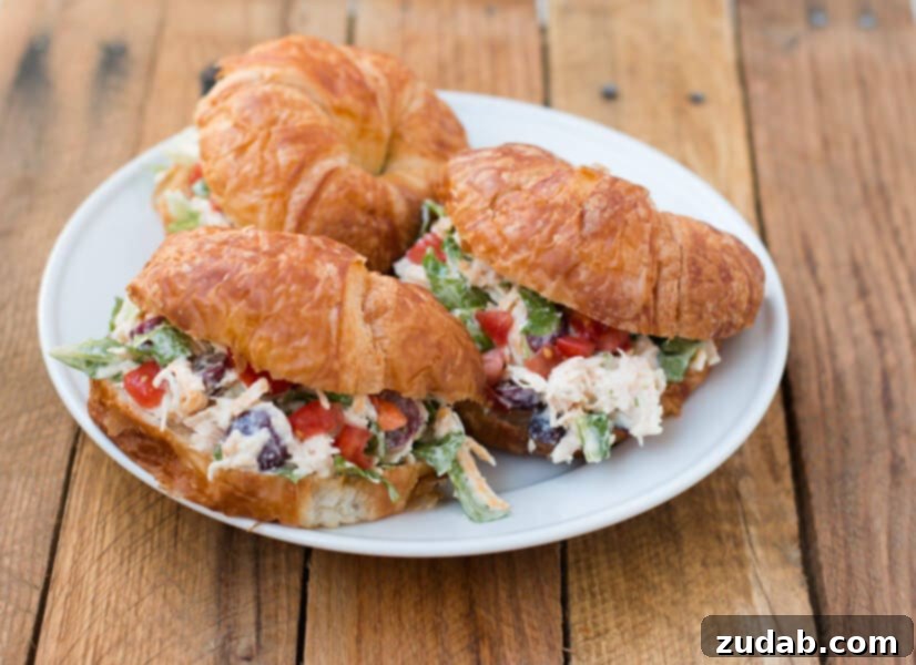 The BEST chicken salad croissant sandwich recipe EVER! ohsweetbasil.com Platter of chicken salad croissant sandwiches ready to serve