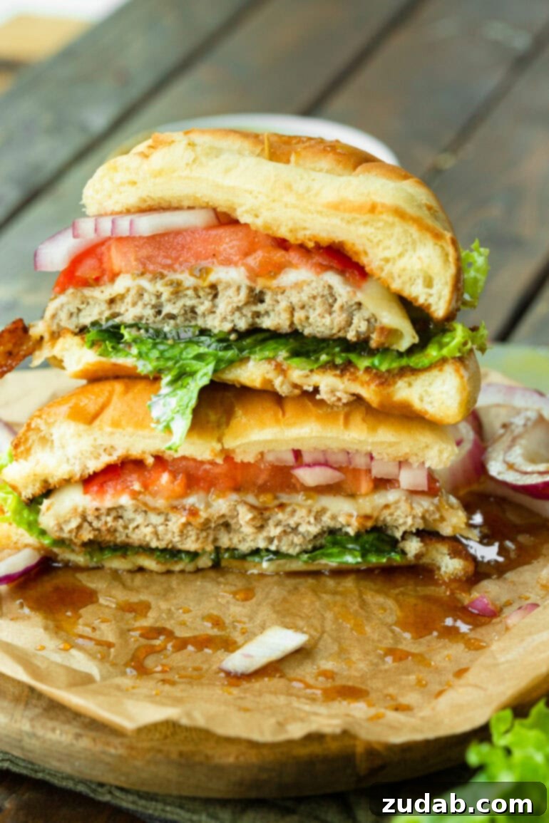 Tropical Heat Turkey Burgers 5 A beautifully presented pineapple jalapeño turkey burger, expertly cut in half to showcase the delicious layers of melted Havarti cheese, fresh tomato, crisp red onion, and a perfectly cooked turkey patty on a brioche bun.